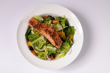 Healthy BLACKENED SALMON SALAD in a dish top view on grey background singapore food