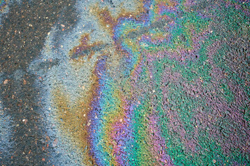Color Gasoline fuel spots on Asphalt Road as Texture or Background. Environmental pollution concept