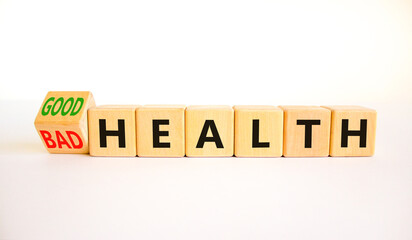 Good or bad health symbol. Turned wooden cubes and changed concept words Bad health to Good health. Beautiful white table white background, copy space. Medical good or bad health concept.