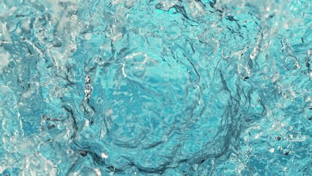 Super slow motion of water surface on light blue background. Filmed on high speed cinema camera, 1000 fps.