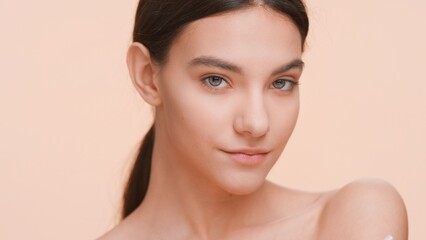 Close-up beauty portrait of young woman looking at camera | Body care and healthy skin.