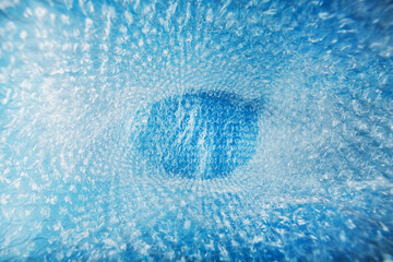 Fototapeta na wymiar Inner space in a bag of packaging air-bubble film on a blue background in full screen