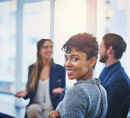 Come join the winning team. Portrait of an attractive young businesswoman smiling and posing during a meeting with her colleagues at work.