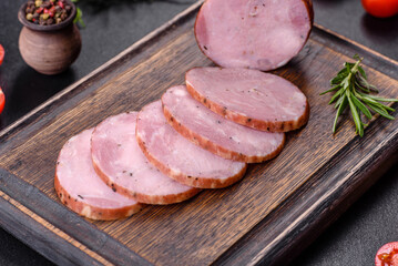 Delicious fresh ham cut with slices on a wooden cutting board