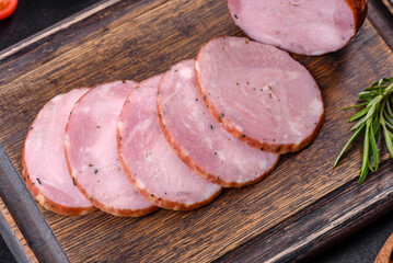 Delicious fresh ham cut with slices on a wooden cutting board