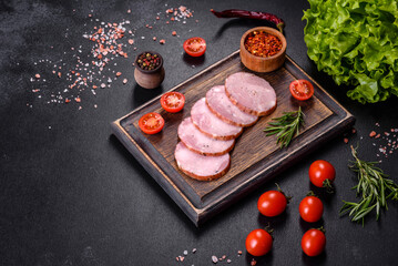 Delicious fresh ham cut with slices on a wooden cutting board