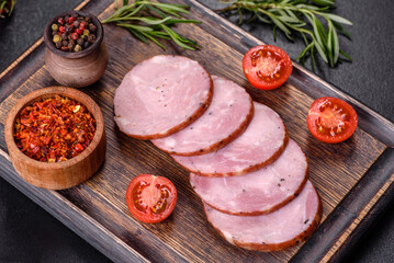 Delicious fresh ham cut with slices on a wooden cutting board