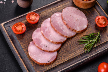 Delicious fresh ham cut with slices on a wooden cutting board