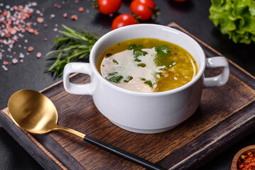Hot tasty healthy soup with fish and vegetables served on a round plate