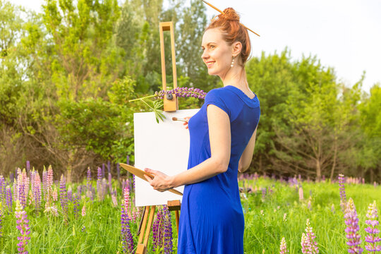Artist woman with easel on nature background
