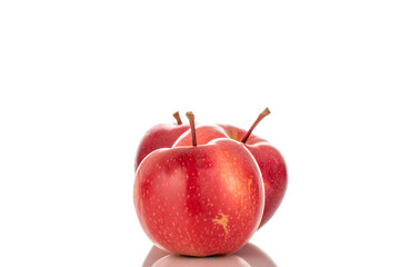 Three ripe red apples, macro, isolated on a white background.
