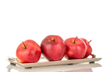 Several ripe red apples on a metal tray, macro, isolated on a white background.