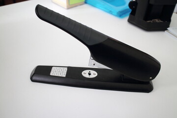 black stapler on white office table