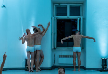 Naked freestyle dancers performing in an indoor setting