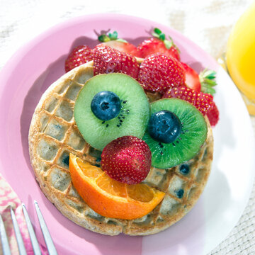 High Angle View Of Fruit On Waffles On A Plate