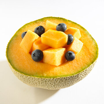 Close-up of blueberries on half of a cantaloupe