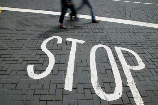Low section view of two people walking