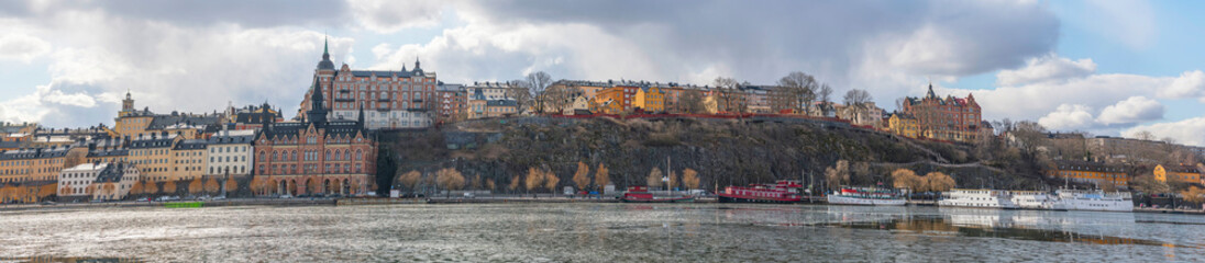 Panorama view over the district Södermalm blocks with houses from the 1700s and the view point board walk Montelius a sunny spring day in Stockholm
