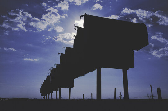 Silhouette of mailboxes in a row
