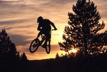 Silhouette of a cyclist in mid-air, Truckee, California, USA