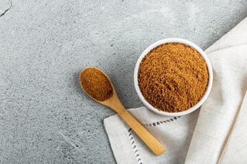 Brown sugar in ramekin on the table.