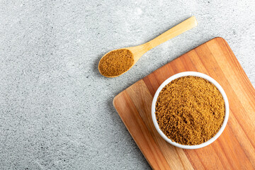 Brown sugar in ramekin on the table.