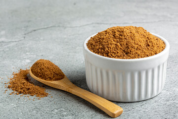 Brown sugar in ramekin on the table.