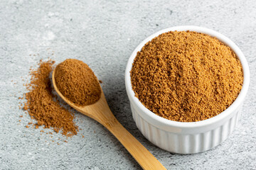 Brown sugar in ramekin on the table.