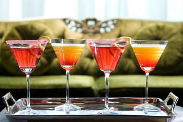 Four glasses of cocktail on a serving tray