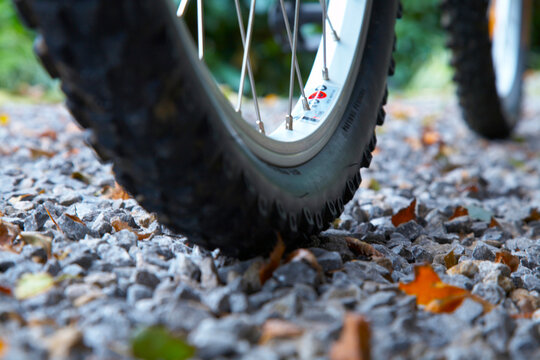 Close-up of bicycle wheels on gravel path