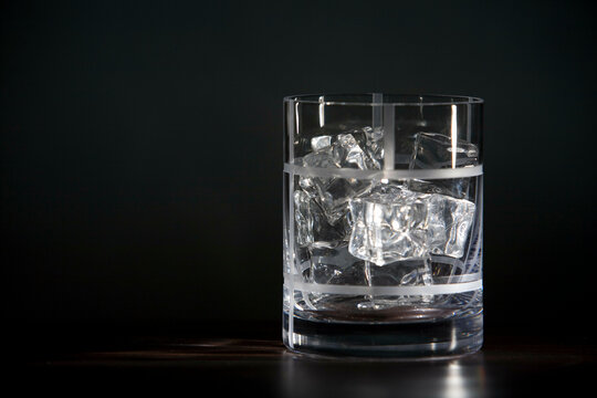 Close-up of a glass full of ice cubes and alcoholic drink
