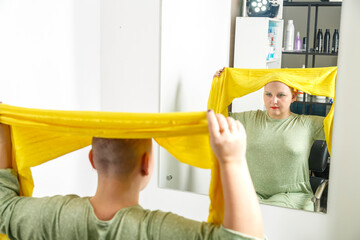 A Jewish Hasidic woman from the Orthodox community cries, shaved bald, puts on a traditional...