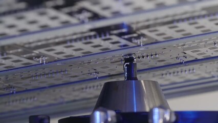 Inside the selective soldering process. Automated machine with liquid solder. The latest creation of electronic boards. Manufacture of electronics in the factory close up. High tech.