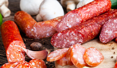 sliced pieces of sausage from meat are lying on a cutting board