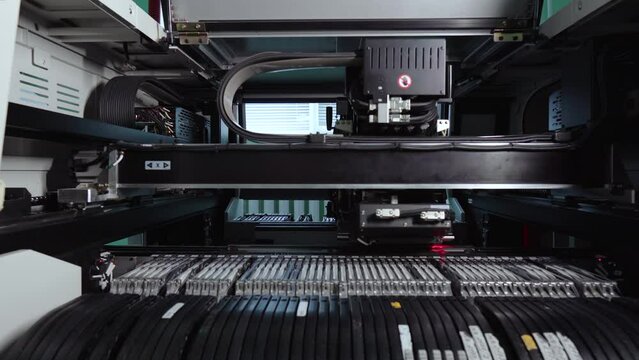 Electronic circuit boards production and installation of SMD components. Automatic equipment places chips and processors. Manufacture of electronic chips. High-tech. Automated robotic concept.