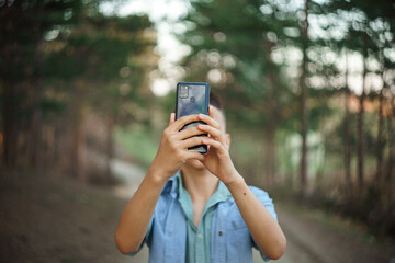 photo boy with a mobile phone in various poses, the concept of modern life