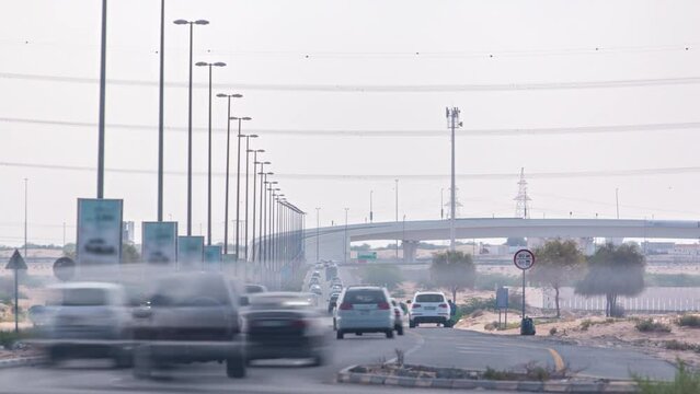 Highway roads with traffic timelapse in a big city from Ajman to Dubai at evening
