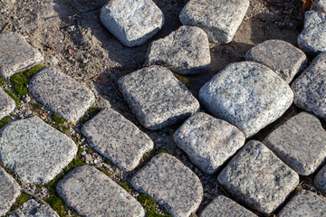 an empty old road made of cobblestones