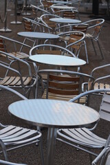 Gleaming metal tables with chairs
