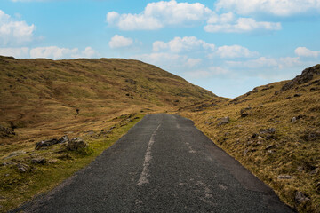 Narrow road towards a mountain peak