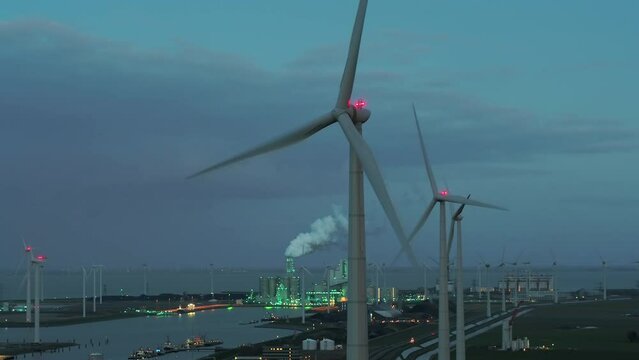 Wind turbine and power station at dusk, Eemshaven, Netherlands