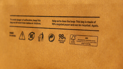 Recycling bag Closeup view of pap sign and other eco-label on Brown paper bag that is 100...