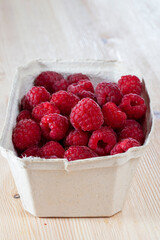 red ripe raspberries in a package