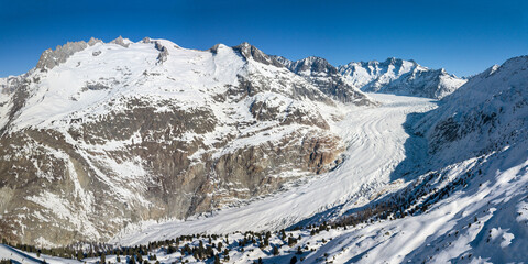 Aerial panorama of Great Aletsch Glacier in Alps winter season, covered with deep snow,...