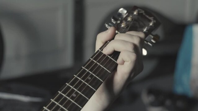 Playing acustic Guitar closeup. People and musical education concept.