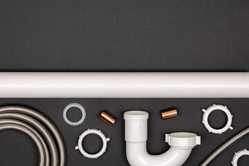 Plumbing supplies and tools displayed in a flat layout on a black background