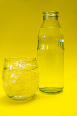 Glass beaker and bottle filled with ice and purified water. vertical orientation