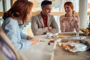 A group of young colleagues is enjoying lunch break at work. Business, people, canteen, company