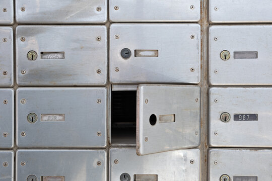 Damaged lock P.O Mailbox hack in the Post Office. Rows of aged mailboxes without lock Private metal mailbox.