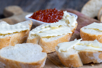 red salmon or trout caviar with white baguette and butter
